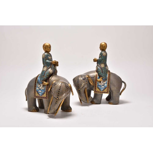 231 - A pair of Chinese cloisonne elephants and riders 19th Century The large mottled greyish lilac enamel... 