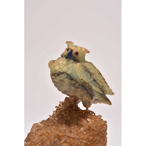 270 - Two carved hardstone models of parrots 20th century The first with an upturned foot, clutching a sma... 