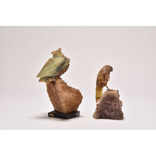 270 - Two carved hardstone models of parrots 20th century The first with an upturned foot, clutching a sma... 