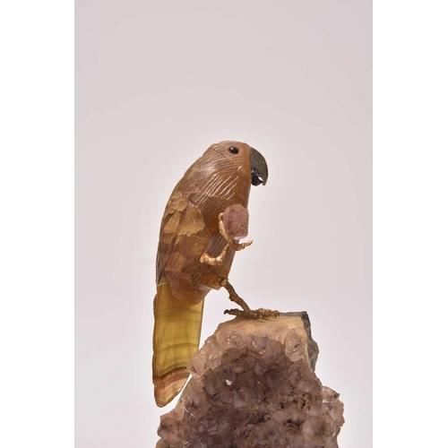 270 - Two carved hardstone models of parrots 20th century The first with an upturned foot, clutching a sma... 