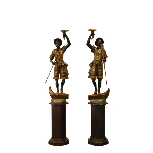 325 - A pair of reproduction painted wood blackamoor figural torchere Each modelled standing atop gondola ... 