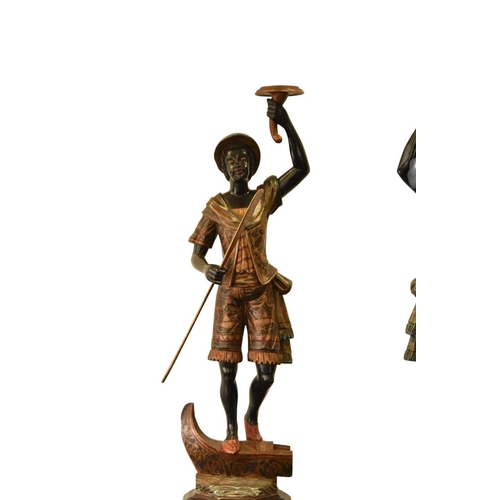 325 - A pair of reproduction painted wood blackamoor figural torchere Each modelled standing atop gondola ... 