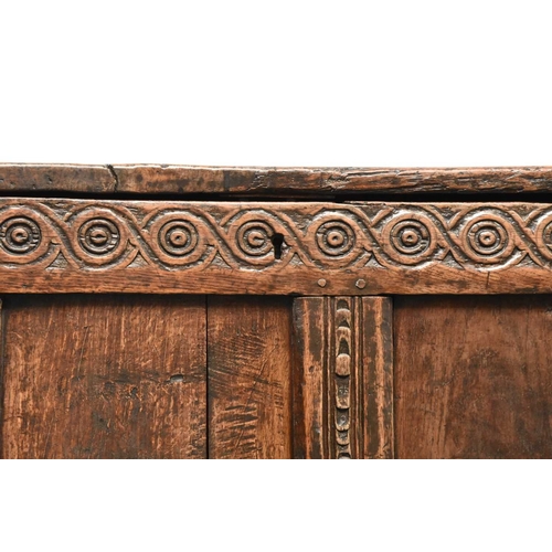 331 - A 17th century oak four panel coffer The plain boarded top opening onto a plain interior, over a gui... 