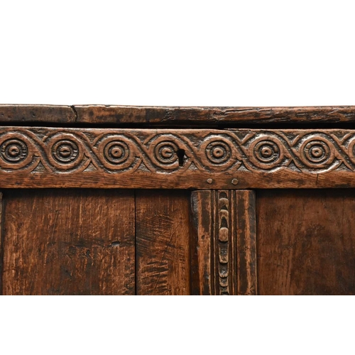 331 - A 17th century oak four panel coffer The plain boarded top opening onto a plain interior, over a gui... 