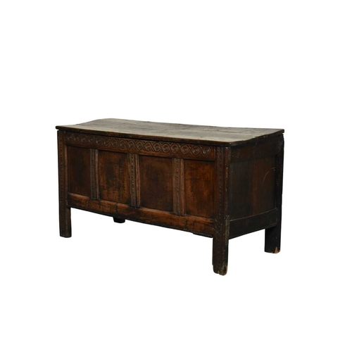 331 - A 17th century oak four panel coffer The plain boarded top opening onto a plain interior, over a gui... 
