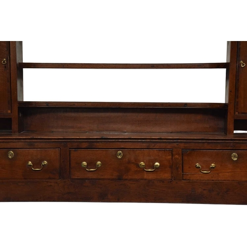 351 - An 18th century oak dresser and rack, Shropshire The associated open rack with cavetto cornice above... 