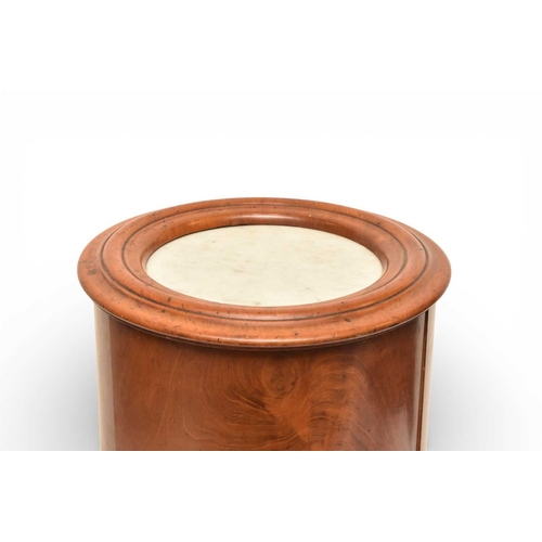 366 - A George III mahogany marble inset drum pot cupboard The molded top over a single door opening onto ... 