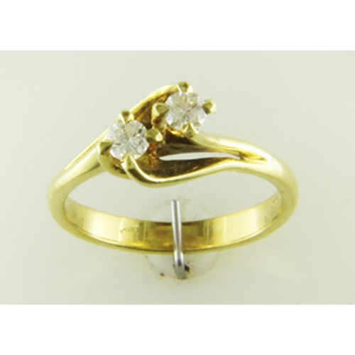 2 - Two round brilliant cut diamonds 0.47 carats are set in this gorgeous 18ct yellow gold crossover rin... 