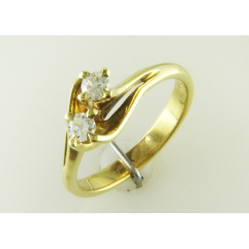 2 - Two round brilliant cut diamonds 0.47 carats are set in this gorgeous 18ct yellow gold crossover rin... 