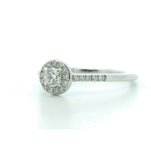 22 - A sparkling natural round brilliant cut diamond is surrounded by a halo of fourteen round brilliant ... 