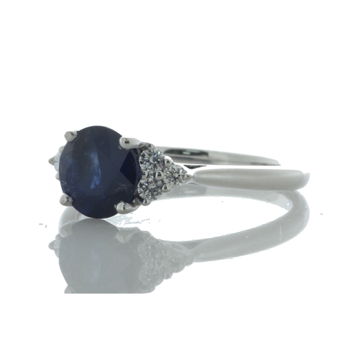 26 - A stunning oval sapphire weighing 1.83 carats sits between six round brilliant cut diamonds on the s... 