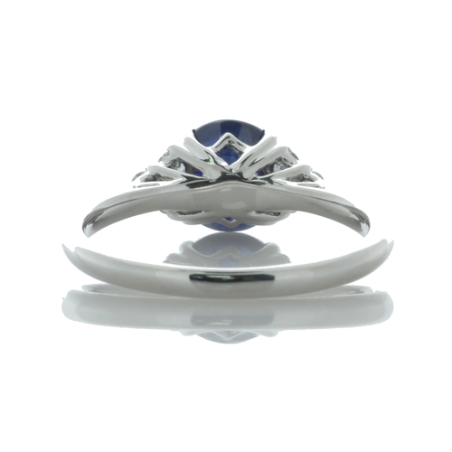 26 - A stunning oval sapphire weighing 1.83 carats sits between six round brilliant cut diamonds on the s... 