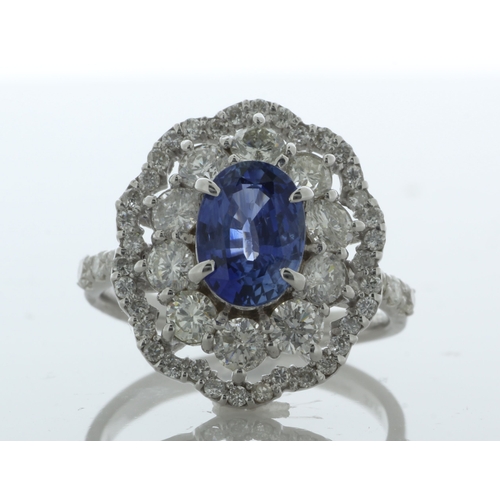 32 - An beautiful oval sapphire is surrounded by a cluster of ten round brilliant cut diamonds which is s... 