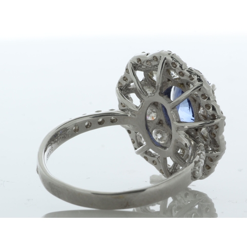 32 - An beautiful oval sapphire is surrounded by a cluster of ten round brilliant cut diamonds which is s... 