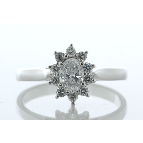 33 - A gorgeous oval diamond is surrounded by a cluster of round brilliant cut diamonds. This stunning 18... 