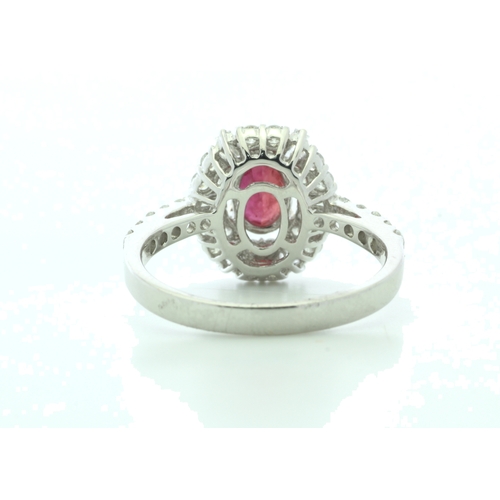 35 - A stunning oval ruby is surrounded by baguette cut diamonds and round brilliant cut diamonds on the ... 