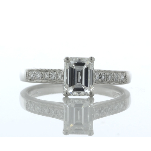 50 - An emerald cut diamond 1.04 carats is set in this stunning shoulder set ring with diamond encrusted ... 