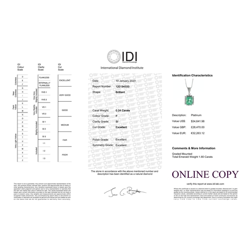 57 - A sparkling emerald cut Colombian emerald sits in a halo of twenty round brilliant cut diamonds on t... 