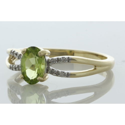 65 - An oval 7mm x 5mm peridot sits between a double band of eight round brilliant cut diamonds set in th... 