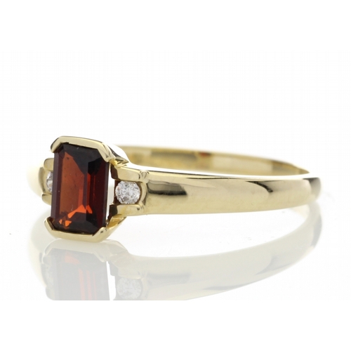 67 - An emerald cut garnet gemstone sits between two round brilliant cut diamonds set into the shoulders ... 