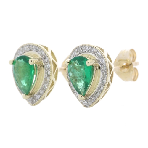 69 - These simple yet classic style stud earrings feature a pear shaped emerald surrounded by a halo of r... 