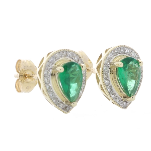 69 - These simple yet classic style stud earrings feature a pear shaped emerald surrounded by a halo of r... 