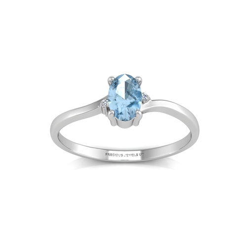 72 - An oval blue topaz is set with one diamond on the shoulder. This 9ct white gold ring is a twist on t... 