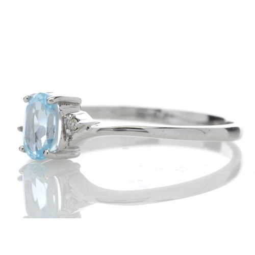 72 - An oval blue topaz is set with one diamond on the shoulder. This 9ct white gold ring is a twist on t... 