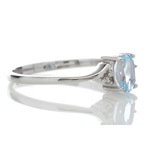 72 - An oval blue topaz is set with one diamond on the shoulder. This 9ct white gold ring is a twist on t... 