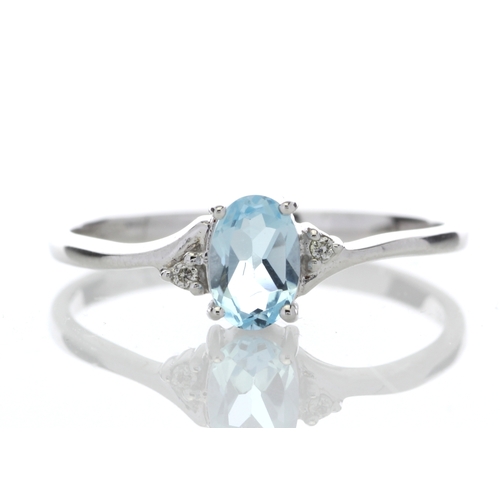 72 - An oval blue topaz is set with one diamond on the shoulder. This 9ct white gold ring is a twist on t... 