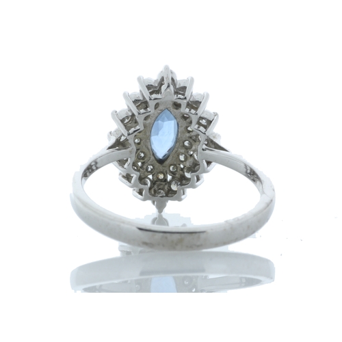 75 - A stunning marquise cut blue topaz gemstone sits surrounded by a double halo set with thirty round b... 