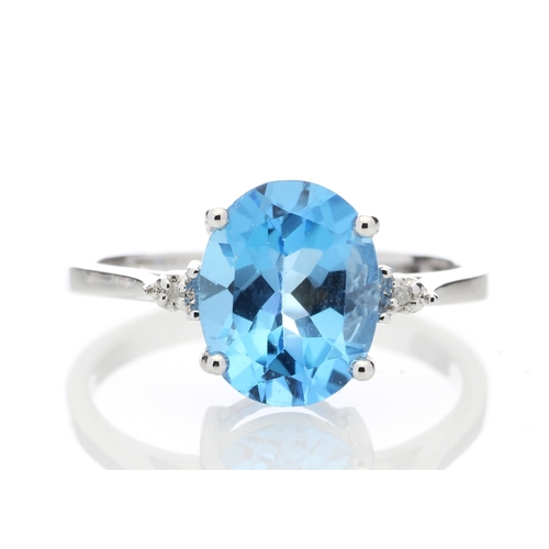 80 - An oval cut Blue Topaz 2.10 carats sits between two round brilliant cut diamonds in this gorgeous 9c... 