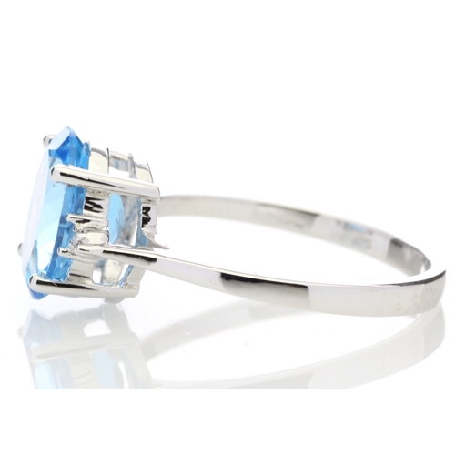 80 - An oval cut Blue Topaz 2.10 carats sits between two round brilliant cut diamonds in this gorgeous 9c... 