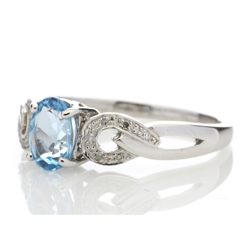 81 - This 0.85 carat oval cut blue topaz sits with six single cut diamonds on the shoulders of this lovel... 