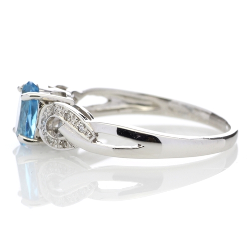 81 - This 0.85 carat oval cut blue topaz sits with six single cut diamonds on the shoulders of this lovel... 