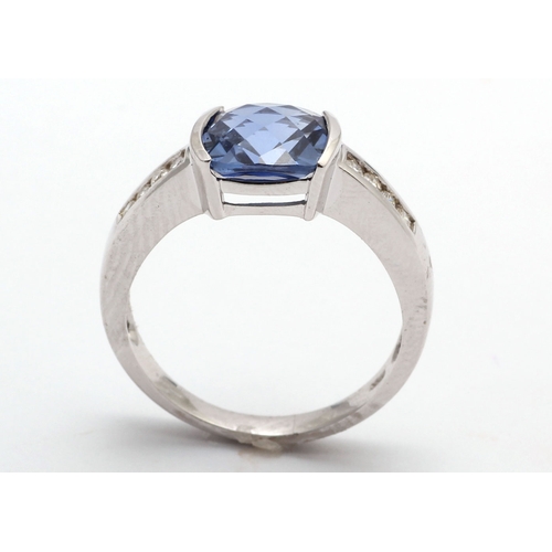 82 - This classic ring with eight round brilliant cut diamond shoulders, with an 8mm by 8mm Ceylon Sapphi... 