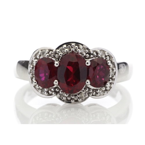 83 - Three oval created rubies are surrounded by a cloud halo of diamonds in this 9ct white gold diamond ... 