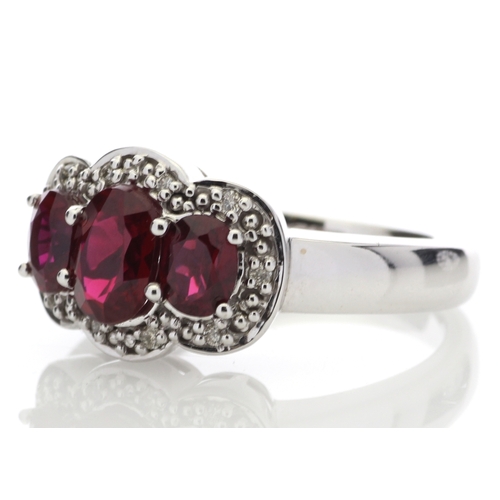 83 - Three oval created rubies are surrounded by a cloud halo of diamonds in this 9ct white gold diamond ... 