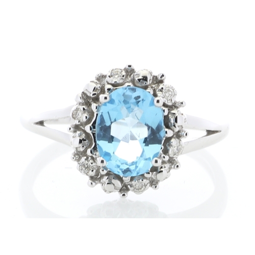 84 - An oval blue topaz is surrounded by a halo or diamonds on this stunning 9ct white gold split shank d... 