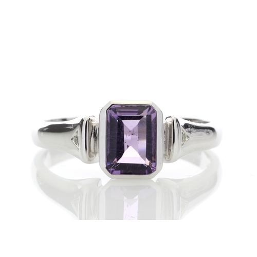 85 - An emerald shaped amethyst 1.00 carats is rub over set with two diamonds in the shoulders of this 9c... 