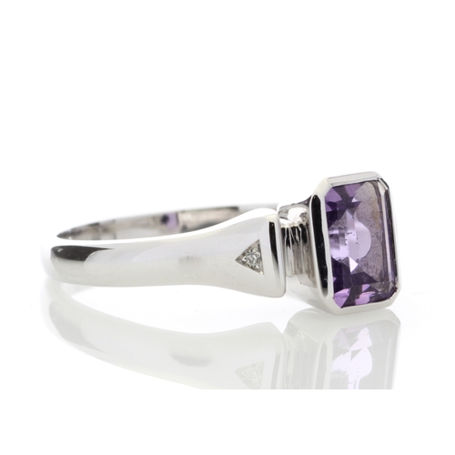 85 - An emerald shaped amethyst 1.00 carats is rub over set with two diamonds in the shoulders of this 9c... 