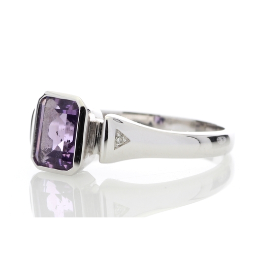 85 - An emerald shaped amethyst 1.00 carats is rub over set with two diamonds in the shoulders of this 9c... 