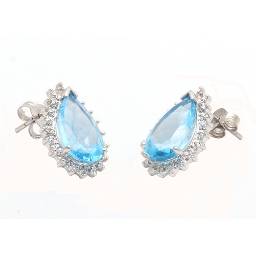 92 - Two pear shaped blue topaz gemstones are surrounded with a halo of diamonds in this stunning stud ea... 