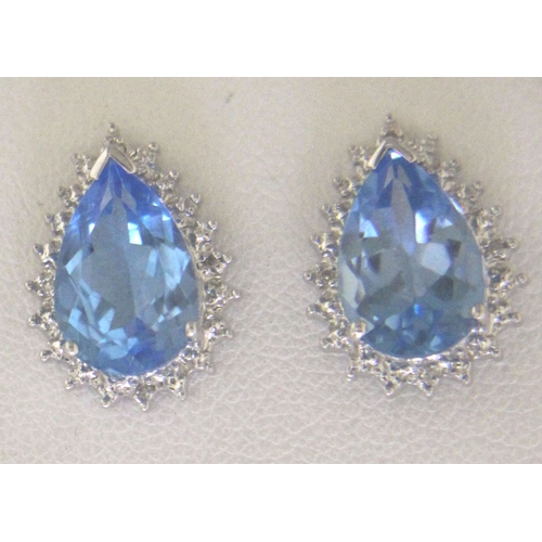 92 - Two pear shaped blue topaz gemstones are surrounded with a halo of diamonds in this stunning stud ea... 