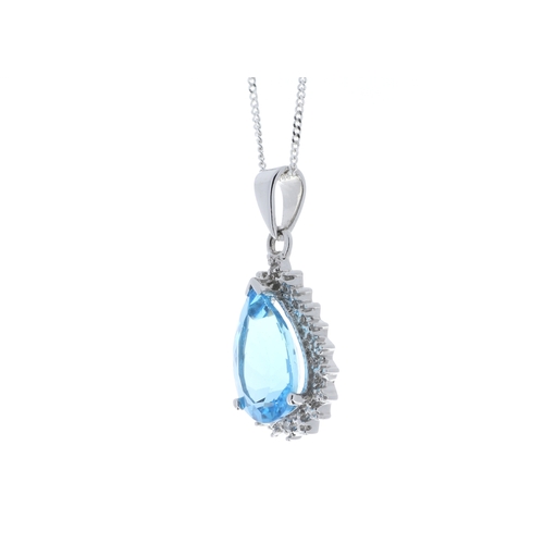 96 - A pear shaped blue topaz gemstone is surrounded by a halo of diamonds. This 9ct white gold pendant i... 