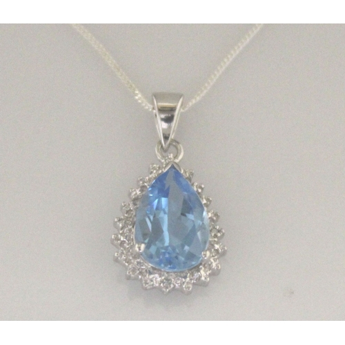 96 - A pear shaped blue topaz gemstone is surrounded by a halo of diamonds. This 9ct white gold pendant i... 