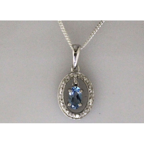 97 - One oval blue topaz gemstone 0.25 carats dangles in the centre of an oval halo set with ten round br... 