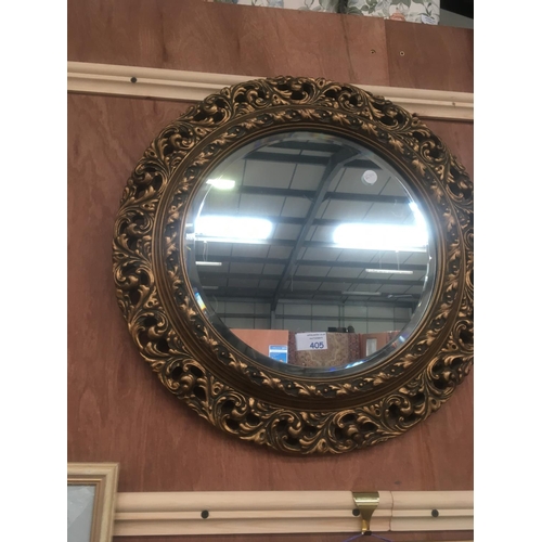 405 - AN ELABORATE CIRCULAR GILT FRAMED MIRROR