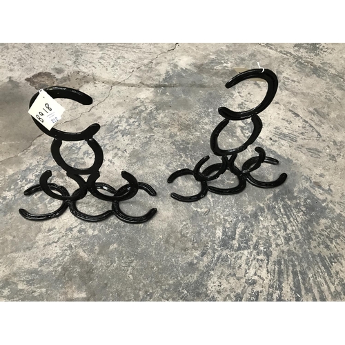 212 - A PAIR OF HORSE SHOE DESIGN BLACK PAINTED METAL HANGING BASKET BRACKETS