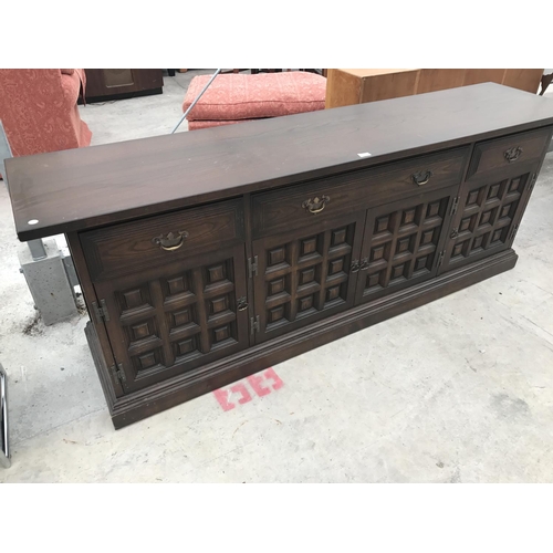 612 - A YOUNGER TOLEDO OAK SIDEBOARD WITH THREE DRAWERS AND FOUR DOORS